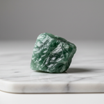 Natural Green Aventurine raw stone for luck and wealth on white marble – Horocosmo
