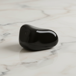 Natural Black Obsidian crystal on white marble – Horocosmo