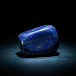 Natural Lapis Lazuli crystal with cool blue glow on dark background – Horocosmo