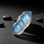 Natural Rainbow Moonstone crystal with glowing moonlight sheen on dark background – Horocosmo