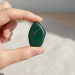 Natural Bloodstone crystal held in hand for scale – Horocosmo