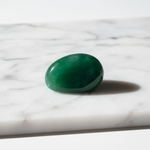 Natural Green Jade stone smooth rich green on white marble – Horocosmo