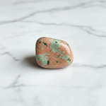 Natural Unakite stone mottled pink and green on white marble – Horocosmo