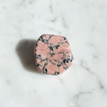Natural Rhodonite stone rose-pink with black veins on white marble – Horocosmo