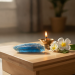 Blue Kyanite crystal on a meditation altar with brass diya – Horocosmo