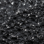 Macro texture of natural Shungite showing carbon-black surface with metallic flecks – Horocosmo