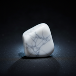 Natural white Howlite stone with cool glow on dark background – Horocosmo