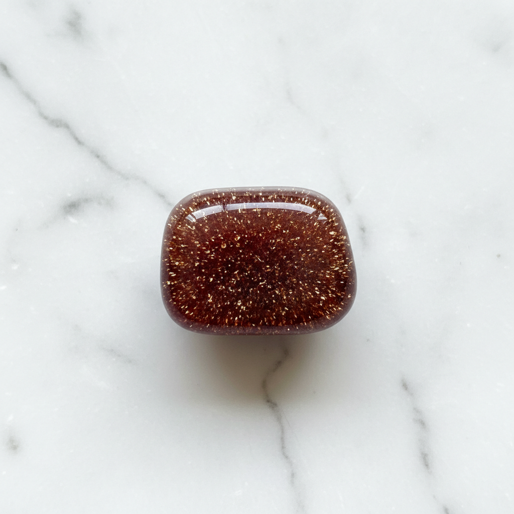 Man-made Goldstone with sparkling copper on white marble – Horocosmo