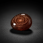 Man-made Goldstone copper glitter on dark background – Horocosmo