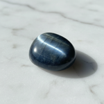 Natural Hawk's Eye blue-grey chatoyant stone on white marble – Horocosmo