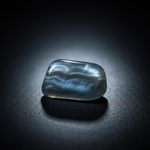 Natural Hawk's Eye stone with silky shimmer on dark background – Horocosmo
