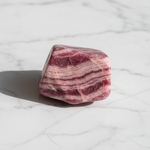 Natural Rhodochrosite rose-pink stone on white marble – Horocosmo