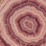 Macro of natural Rhodochrosite showing rose-pink banding – Horocosmo