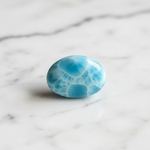 Natural Larimar ocean-blue stone on white marble – Horocosmo