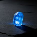 Natural Blue Apatite vivid blue stone with glow on dark background – Horocosmo