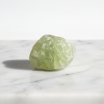 Natural Prehnite yellow-green stone on white marble – Horocosmo