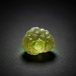 Natural Prehnite yellow-green stone with glow on dark background – Horocosmo