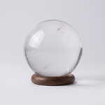 Natural Clear Quartz (Sphatik) crystal ball on wooden stand – representative image; each natural stone varies slightly in clarity and inclusions